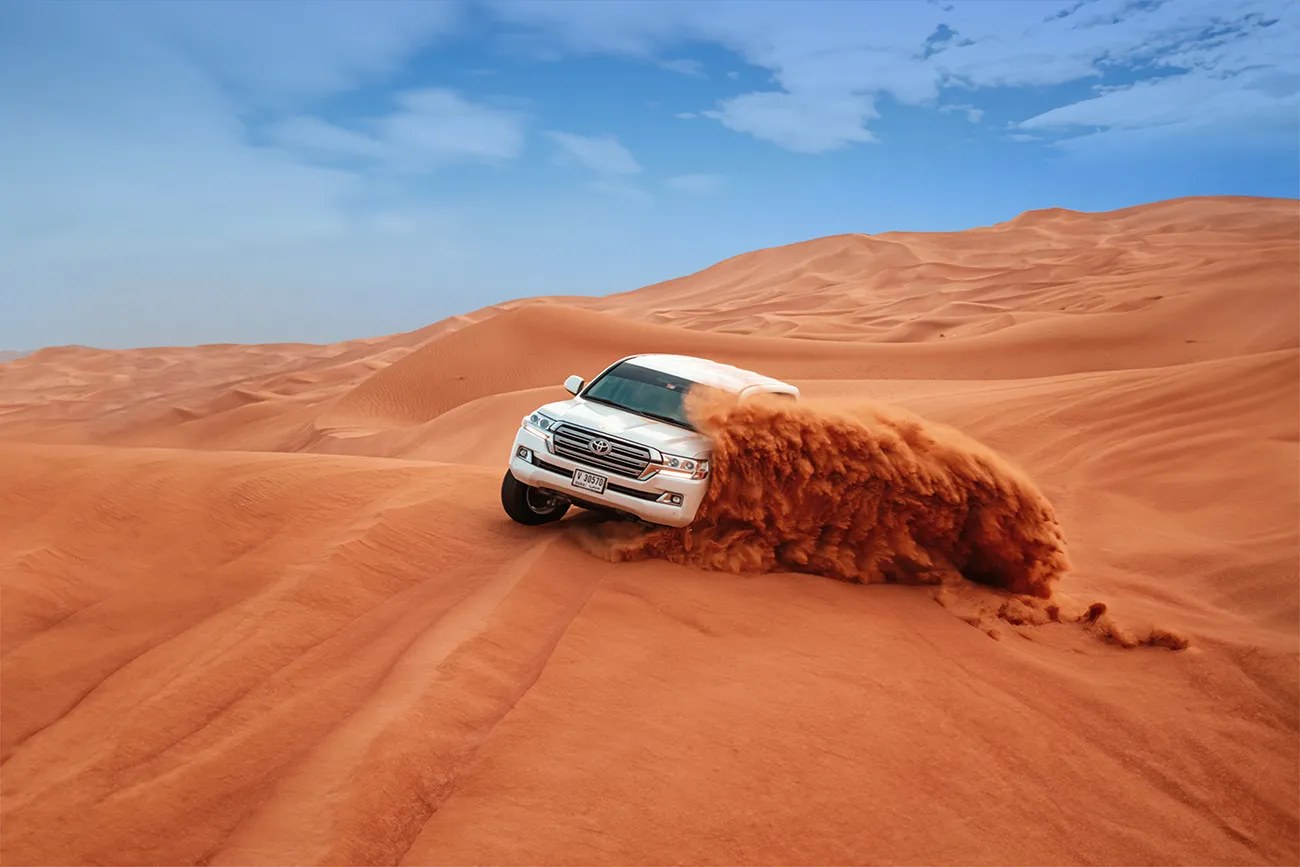 White 4x4 dune bashing in the desert
